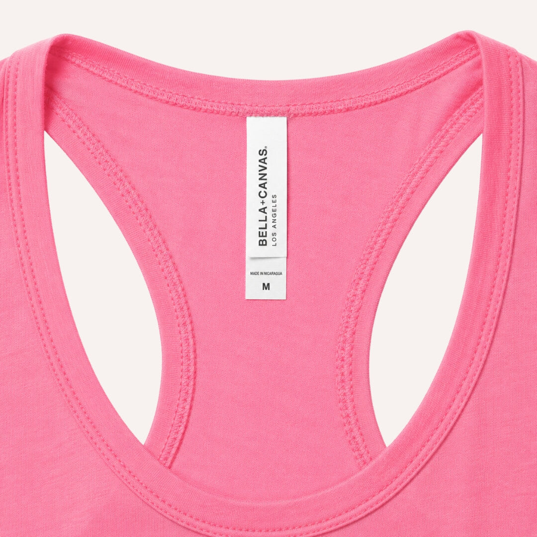 Close up of Bella + Canvas Women's Racerback Tank Top charity pink tag and fabric detail