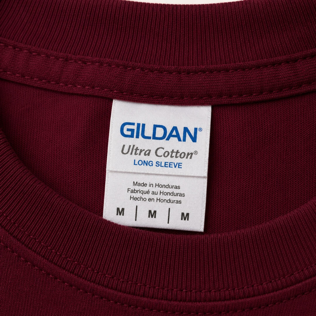 Close-up of Gildan Ultra Cotton Long-Sleeve T-Shirt tag and fabric detail in Maroon