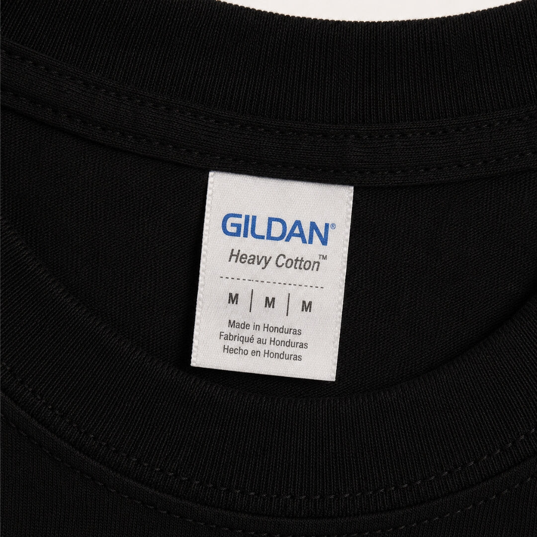 Close-up of Gildan Youth Heavy Cotton T-Shirt tag and fabric detail in Black